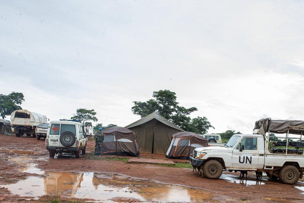 UN vehicles parked outside of tents.