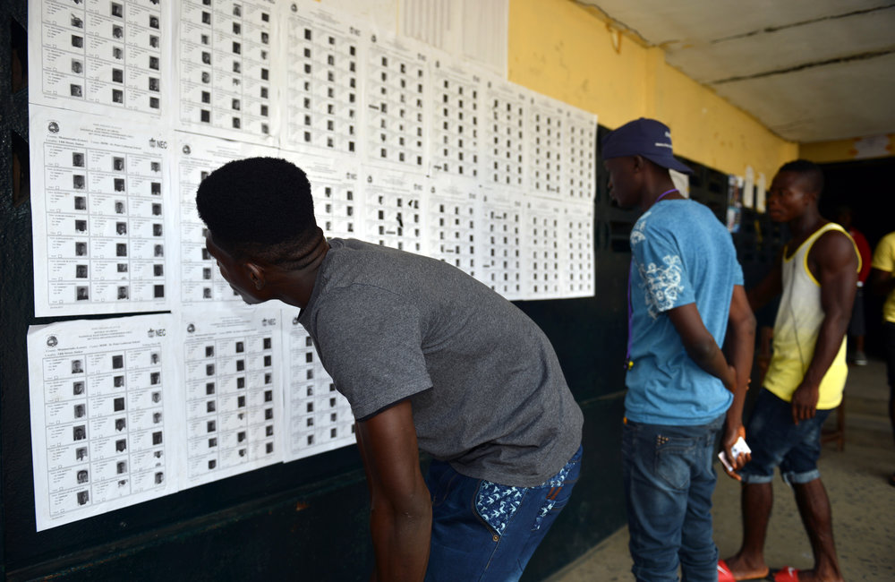 26 December 2017, Presidential Runoff Election Voters looking for their information in a voter precinct.  ©UNMIL Photo: Shpend Berbatovci