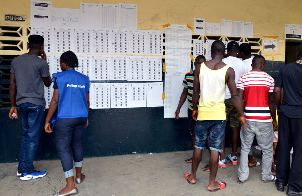 26 December 2017, Presidential Runoff Election Voters looking for their information in a voter precinct.  ©UNMIL Photo: Shpend Berbatovci